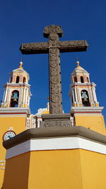 Low angle view of bell tower against blue sky