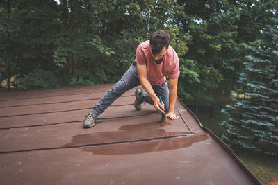 Side view of man walking on boardwalk