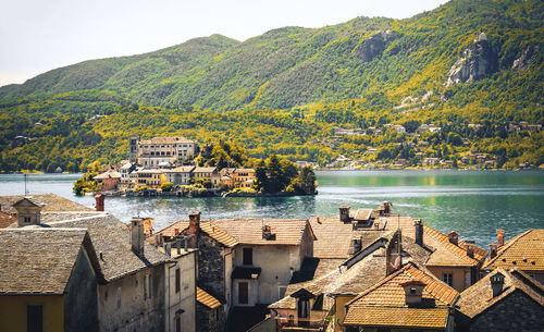 Scenic view of lake by buildings against sky