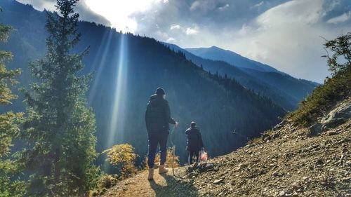 Rear view of people walking on mountain