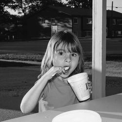 Portrait of girl eating outdoors