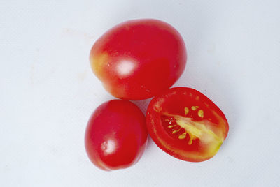 Close-up of tomatoes against white background