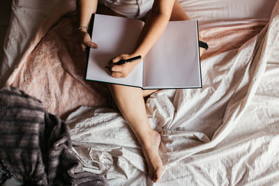 High angle view of woman lying on bed