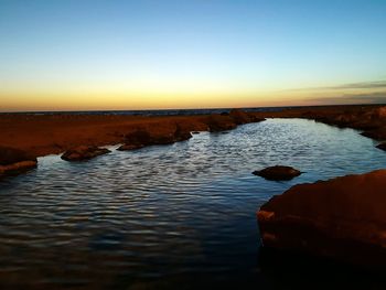 Scenic view of sea against sky at sunset