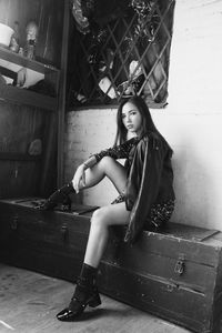 Portrait of young woman sitting on floor