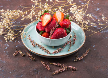 High angle view of strawberries in plate on table