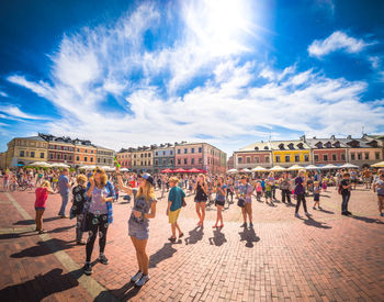 People at town square against blue sky