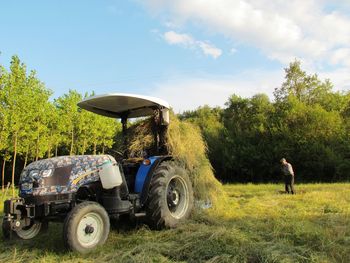 Tractor on field against sky