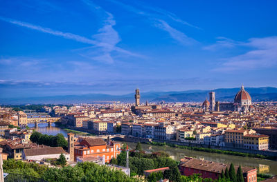 High angle shot of townscape against blue sky