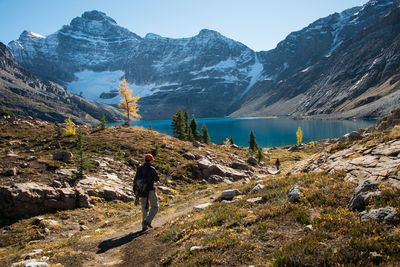 Man standing on mountain against sky