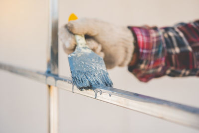 Cropped hand of painter painting