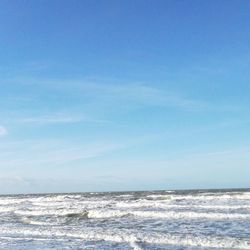 Scenic view of sea against blue sky