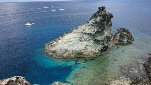 High angle view of rocks by sea