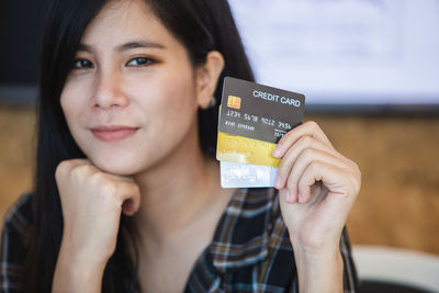 Portrait of young woman using mobile phone