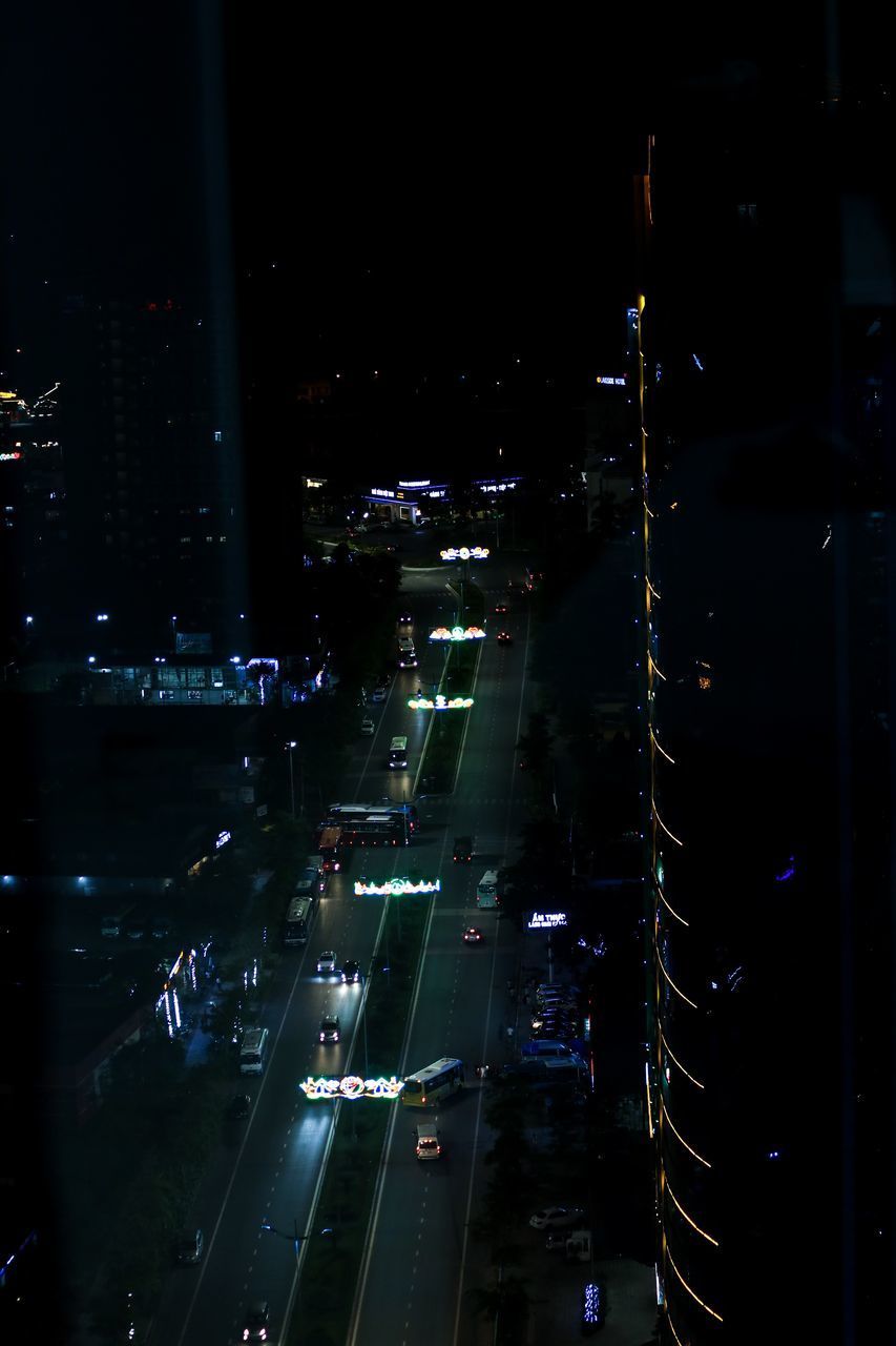 HIGH ANGLE VIEW OF ILLUMINATED CITY BUILDINGS AT NIGHT