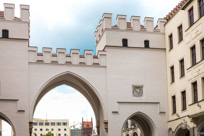 Low angle view of buildings in town against sky