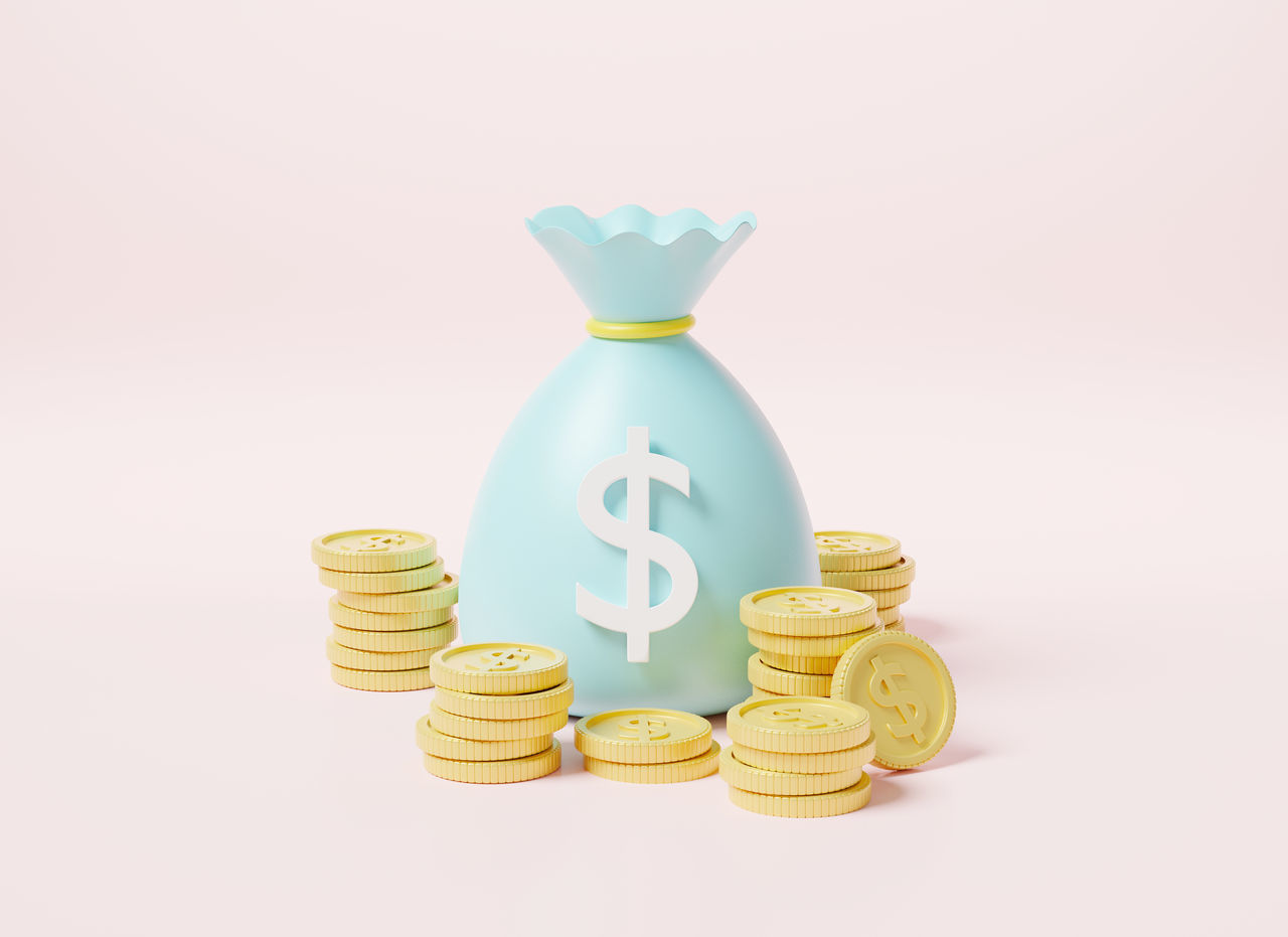 CLOSE-UP OF COINS ON WHITE BACKGROUND AGAINST GRAY