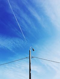 Low angle view of vapor trails against sky