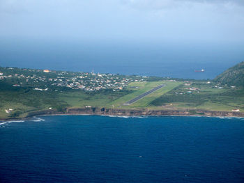 Scenic view of sea and cityscape against sky