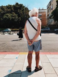 Rear view of a man standing on road