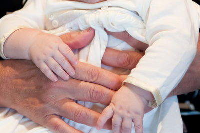 Close-up of couple holding hands