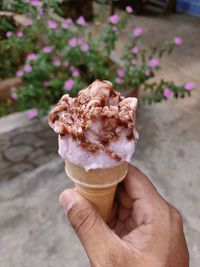 Close-up of hand holding ice cream cone