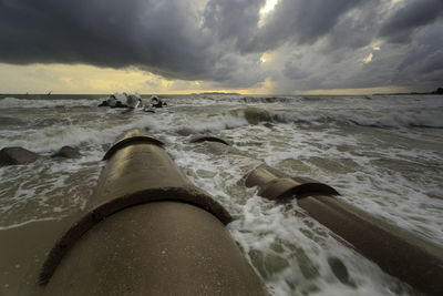 Low section of person in sea against sky