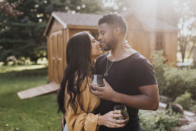 Young couple in drinking glass