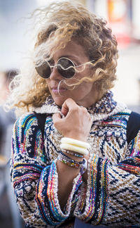 Young woman wearing sunglasses while standing outdoors