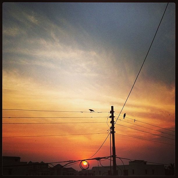 power line, sunset, electricity pylon, power supply, silhouette, electricity, connection, sky, low angle view, cable, technology, fuel and power generation, cloud - sky, power cable, orange color, cloud, dusk, street light, transfer print, outdoors