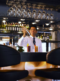 Bartender making cocktail in bar