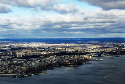 High angle view of river by buildings against sky