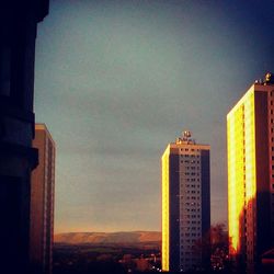 Buildings in city at sunset