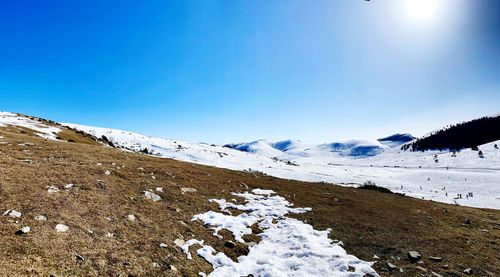 Scenic view of snowcapped mountains against clear blue sky