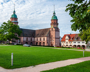 Lawn by building against sky