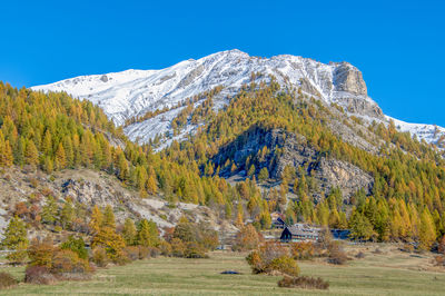 Scenic view of mountains against clear blue sky