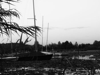 Boats moored in calm lake