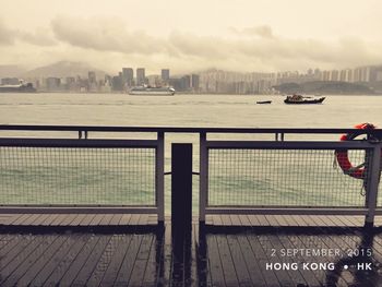 View of cityscape against cloudy sky