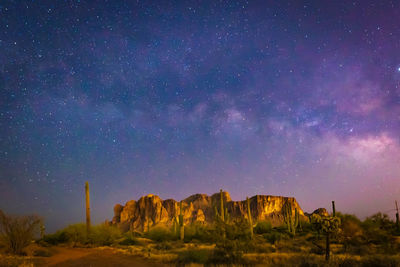 Scenic view of rock formation against sky at night