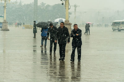People walking on wet road in rain