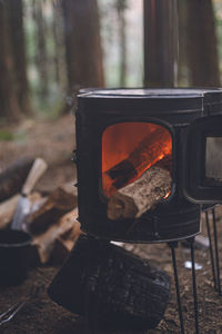 Winter camping. chopping wood with an axe and stoking the wood stove.