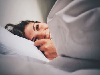 Side view of young woman in bed