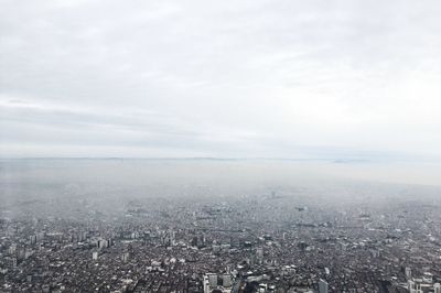 High angle view of city buildings against sky