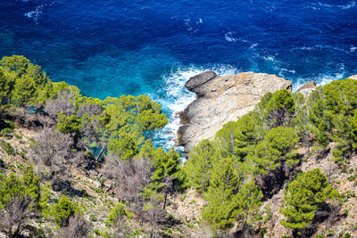 High angle view of rocks by sea