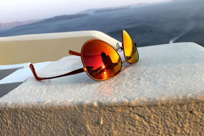 Close-up of sunglasses on beach