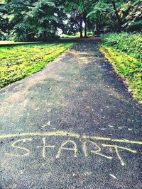 Text on road against trees