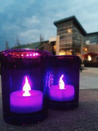 Close-up of lit candle in dark room