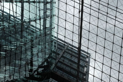 Double exposure of modern building against sky