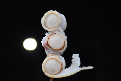 Close-up of cake on table against black background