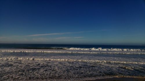 Scenic view of beach and sea against clear sky